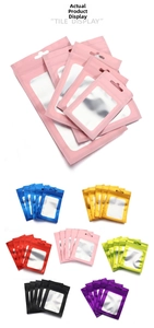 Detailed view of colorful matte pouches with clear windows and top hanging holes