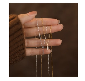 Macro shot of minimalist s925 silver bar pendant necklaces in gold and silver finishes