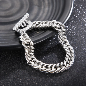Classic silver stainless steel cuban chain bracelet featuring a decorative OT toggle clasp