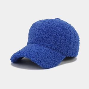 Close-up of fluffy blue sherpa baseball cap showing soft grainy fleece texture detail