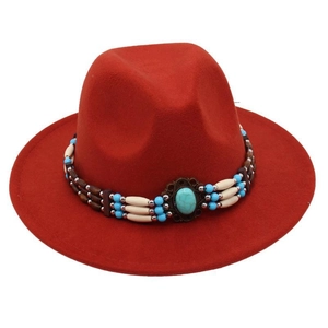 Detail of red fedora hat with ethnic turquoise beads and brown wooden bead hatband