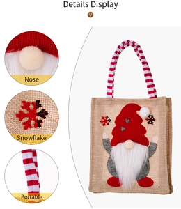 Detailed display of burlap Christmas bag with gnome nose, snowflake embroidery and handle