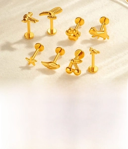 Detail of titanium alloy lip stud featuring gold zircon animal shapes and 16G rod size