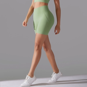 Side view of high-waisted seamless light green yoga shorts with slimming compression fit