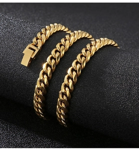 Macro shot of gold stainless steel Cuban chain necklace with secure lobster clasp