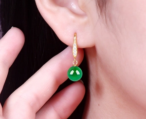 Close-up of S925 silver gold-plated earring with green chalcedony and zircons