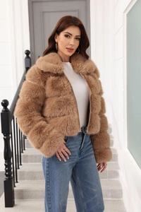 Close-up of khaki faux fur jacket with square patchwork design and metal zipper detail