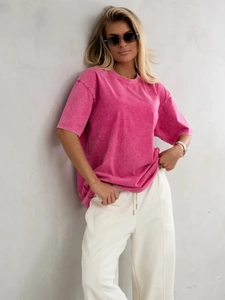 Detail of rose pink acid wash oversized cotton t-shirt with white drawstring trousers
