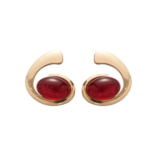 Vintage style gold earrings with large oval red resin gemstones on white background