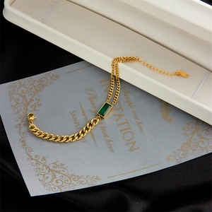 Elegant gold stainless steel cuban chain bracelet with emerald green rectangular gemstone