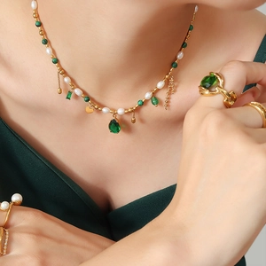 Elegant gold necklace and ring set with white pearls and green malachite on model