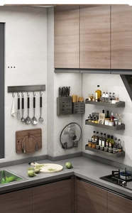 Detail of gunmetal wall-mounted kitchen rack with knife holder and seasoning shelves
