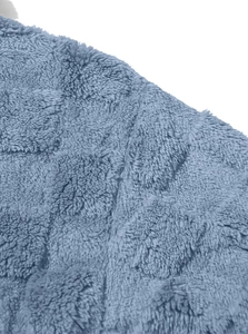 Detailed macro shot of grey-blue fleece fabric with square embossed texture for men hoodie
