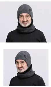 Detail of men's winter knit hat and scarf set showing gray wool blend texture and ear protection