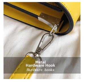 Close-up of bright yellow handbag showing polished silver hardware hooks and stitching