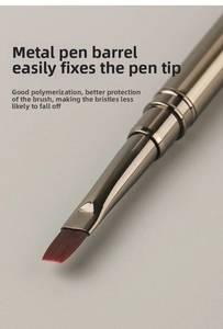 Detail shot of a professional flat angled nail art brush with a gunmetal metal barrel