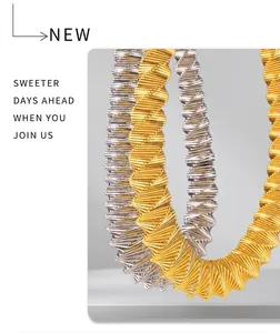 Detailed macro view of spiral woven metal necklace in gold and silver finish