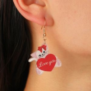 Close-up of cute acrylic cat earring with red bow and Love you heart pendant