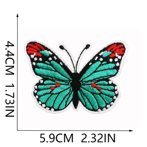 Detail view of blue butterfly embroidery patch with dimensions 5.9cm x 4.4cm