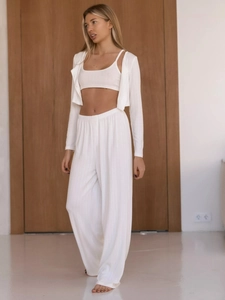 Close-up of white knit three-piece lounge set featuring vertical rib texture and fabric details