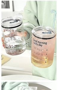 Detail of clear glass tumblers featuring printed time markers and motivation text