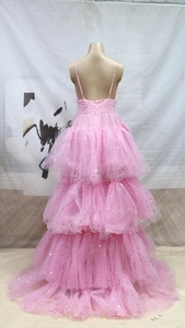 Rear view detail of a tiered pink mesh gown with silver star sequins and open back straps