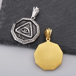 Detail of octagonal Eye of Providence pendant in gold and silver finish on stone