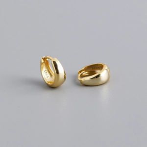Macro shot of 925 sterling silver stamp on gold-plated wide band earrings