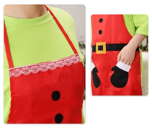 Detail of Christmas apron showing lace neckline and glove-shaped pocket with red festive design
