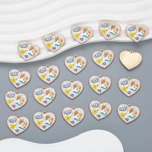 Macro shot of colorful enamel heart charms with evil eye motifs for jewelry making