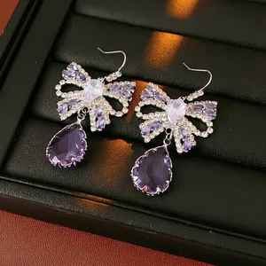 Elegant purple bow earrings with zircon and drop-shaped crystal in palace style