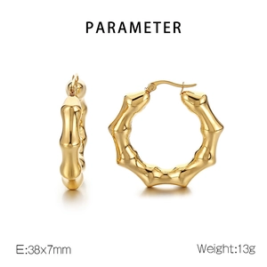 Macro detail of gold U-shaped bamboo earrings showing 38x7mm dimensions and metal texture
