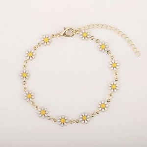 Elegant gold daisy bracelet with white enamel petals and adjustable extension chain