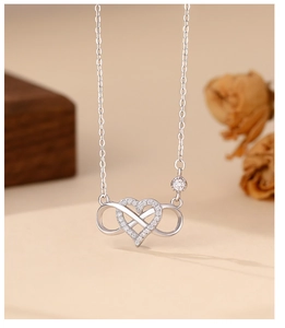 Close-up of S925 silver infinity heart necklace with micro-pave white cubic zirconia