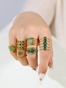 Detail of 18k gold-plated stainless steel rings featuring natural green malachite stones