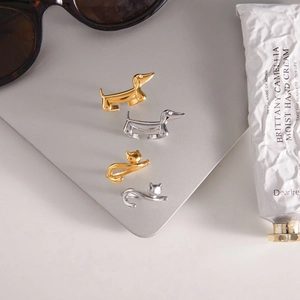 Macro detail of dog and cat animal rings with sparkling zircon eyes in gold and silver finish