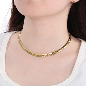 Close-up of gold flat Cuban link chain necklace on model neck showing trendy NK style