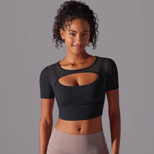 Close-up of black sports crop top featuring mesh patchwork and front cutout design