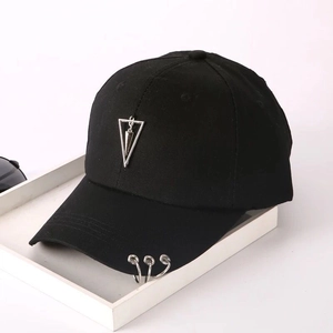 Detail of black cotton baseball cap with silver metal rings and triangle charm accessory
