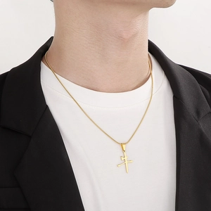 Close-up of a gold stainless steel necklace featuring a Chinese 'Niu' character pendant