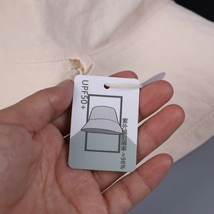 Macro shot of sun hat tag showing UPF 50+ rating and UV protection fabric detail
