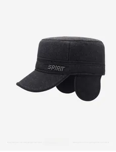 Detailed view of winter flat top cap featuring thick tweed fabric and ear protection flaps