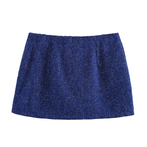 Detail shot of navy blue tweed skirt showing the intricate woven fabric texture and A-line cut