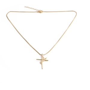 Close-up of golden metal cross necklace with zircon stones on plain white background