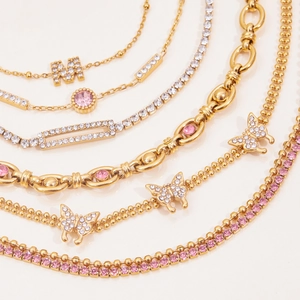 Gold-plated stainless steel butterfly bracelet with pink zircon stones and letter M pendant