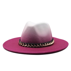 Detail of white to rose red gradient fedora hat with gold metal chain accent
