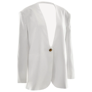 Detailed view of a white slim fit blazer with deep V-neck and single button closure
