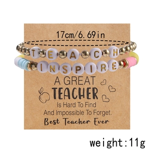 Detail of colorful polymer clay teacher bracelets set with TEACH and INSPIRE beads