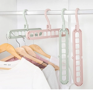 Detail of 9-hole magic hanger showing horizontal and vertical space-saving modes in a closet