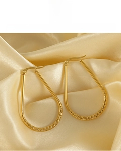 Close-up of 18K gold plated drop earrings with vintage hammered texture detail